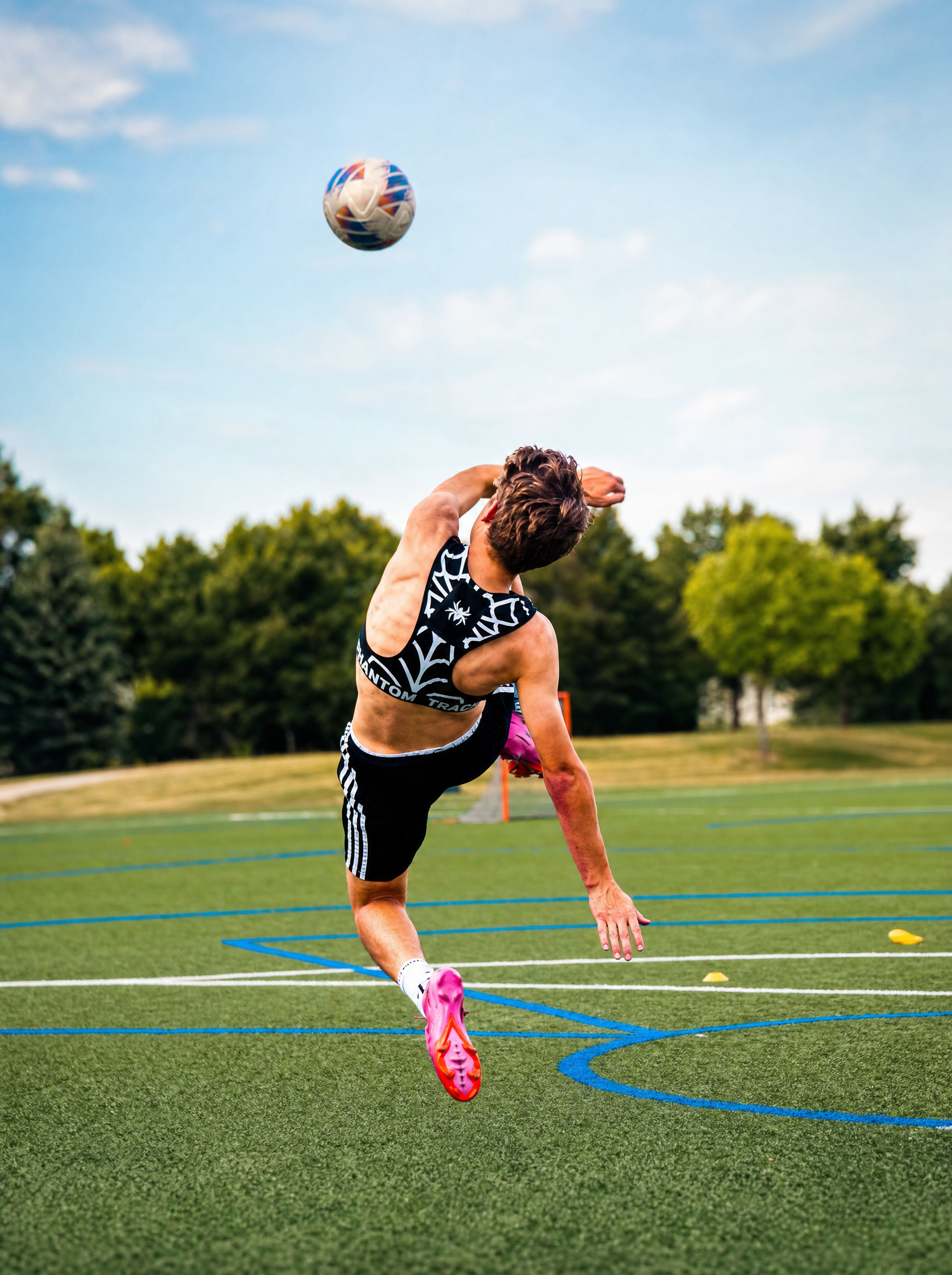Athlete wearing the Phantom Vest mid bicycle kick on the pitch